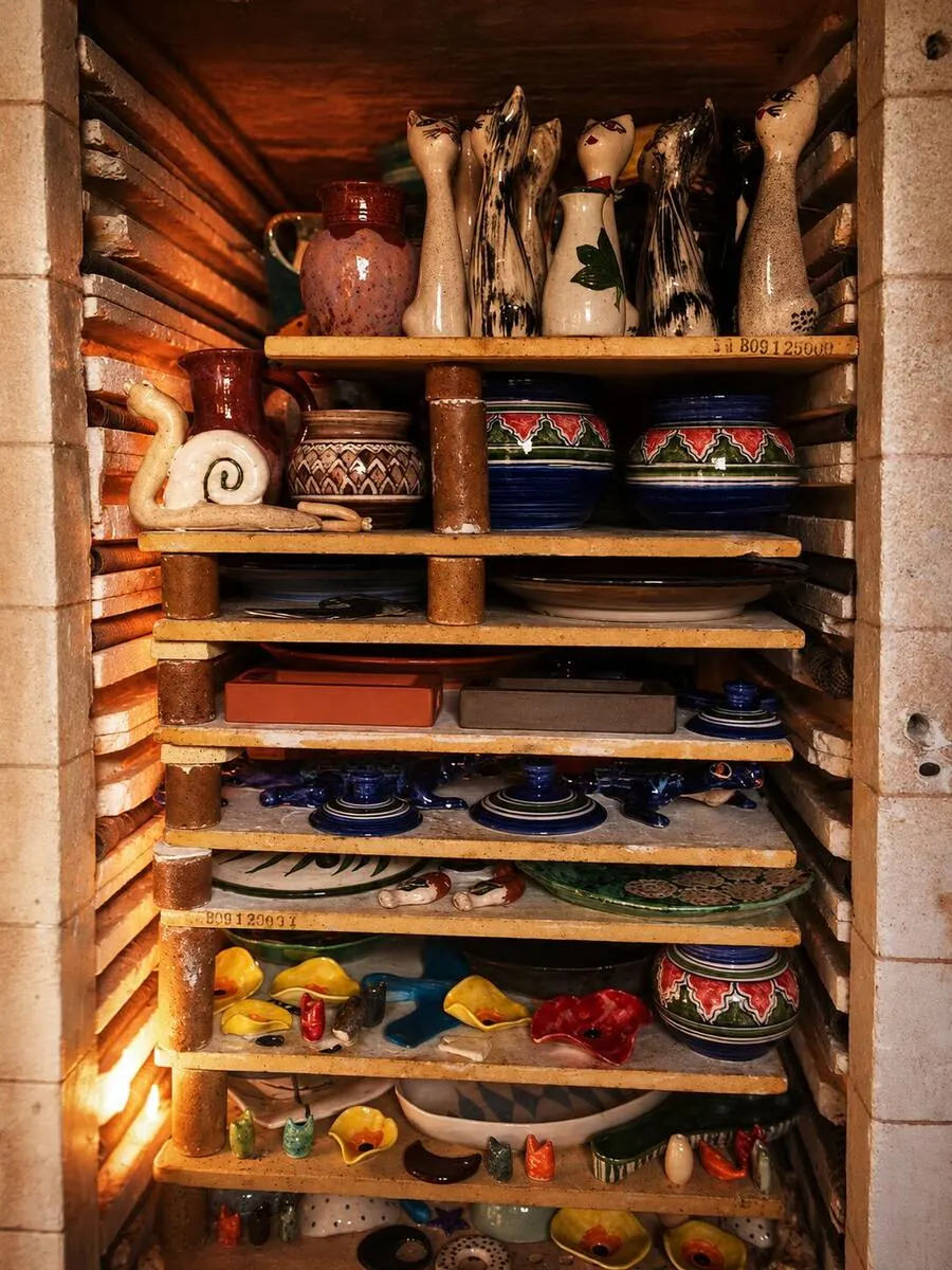 Finished Dizayn74 ceramics glowing on the shelves of the studio kiln